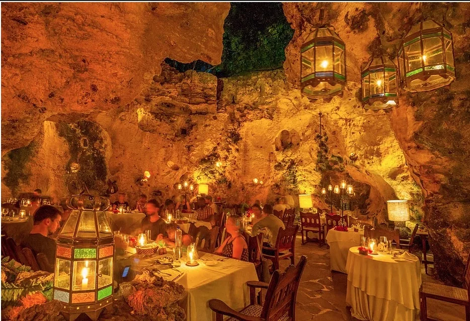 Candlelit tables inside a natural cave in Diani